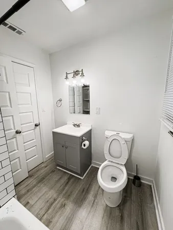 a spacious bathroom with a toilet sink and mirror