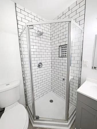 a bathroom with a shower toilet and sink