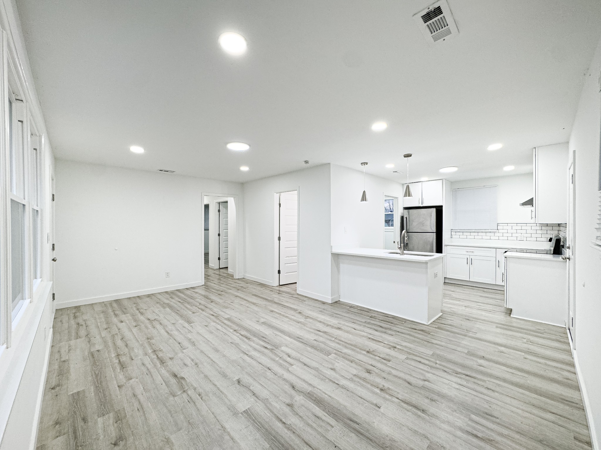 1307 Jarrett Drive Springfield, TN 37172 - Photo 3 of 20 a view of kitchen with kitchen island a sink wooden floor and a refrigerator