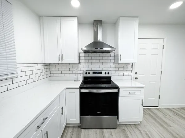 a kitchen with a stove and a sink