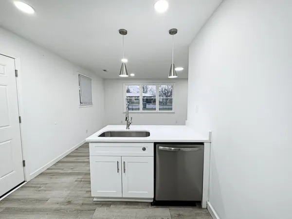 a room with a sink cabinets and window