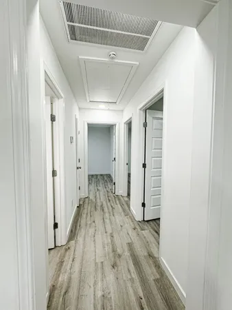 a view of hallway with wooden floor