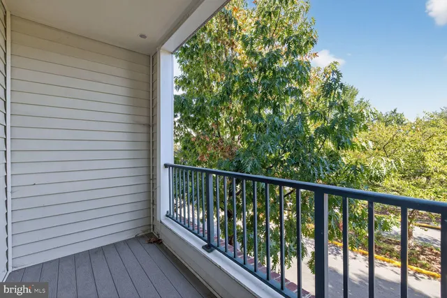 a view of a balcony with wooden floor