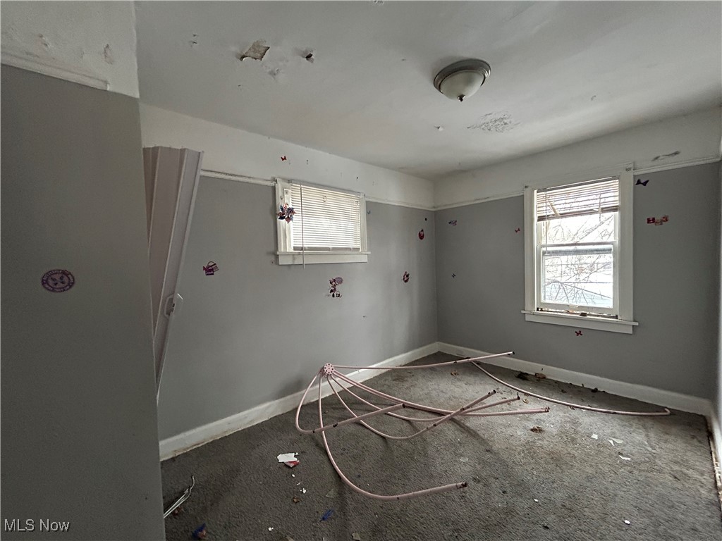 15218 Ridpath Avenue Cleveland, OH 44110 - Photo 11 of 11 Empty room with baseboards and plenty of natural light