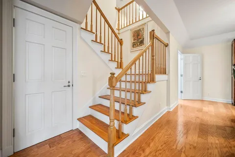 a view of entryway and hall with wooden floor