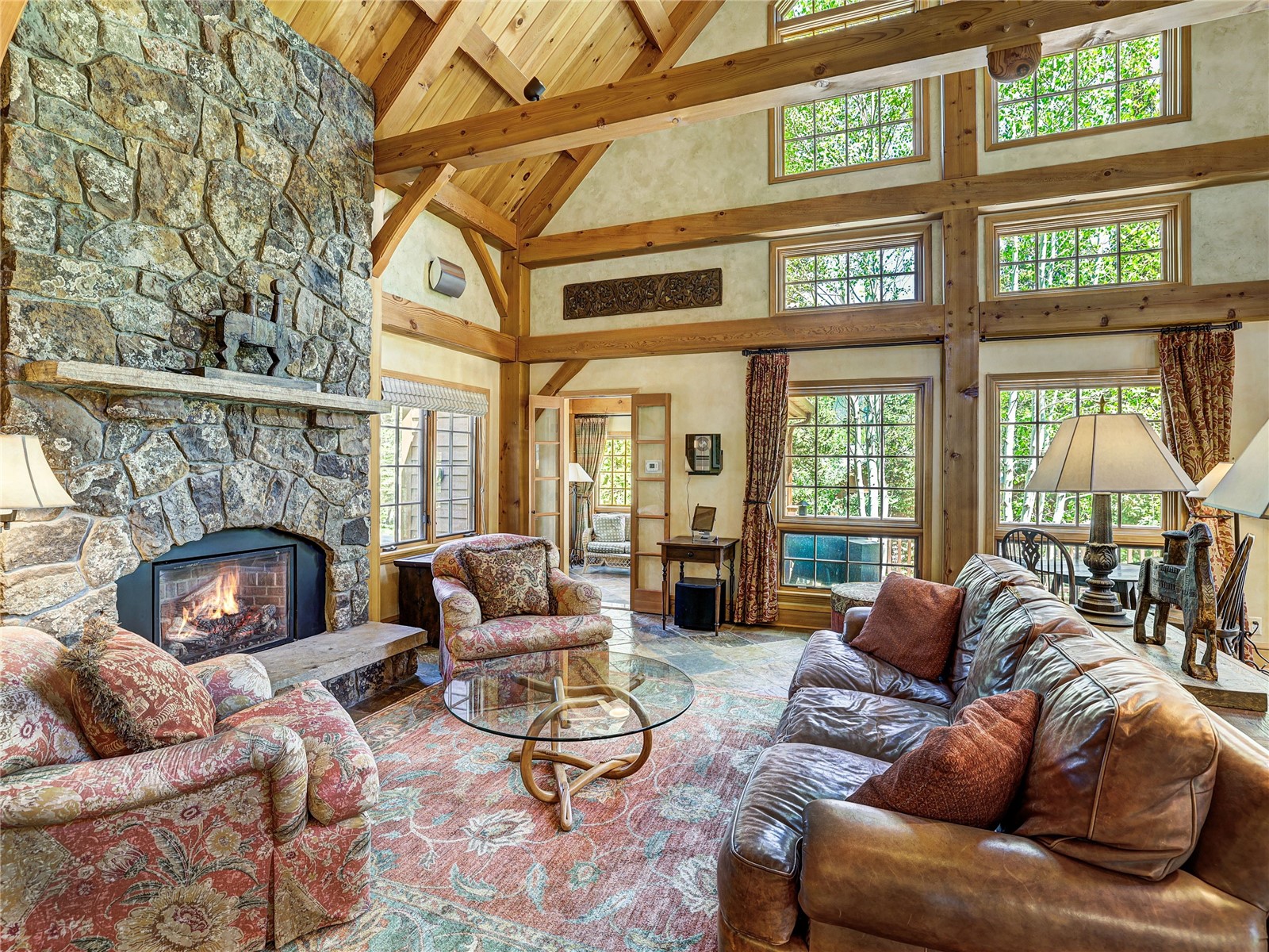 840 Penstemon Road Keystone, CO 80435 - Photo 5 of 50 Living room featuring high vaulted ceiling, a fireplace, and a wooden ceiling with exposed beams
