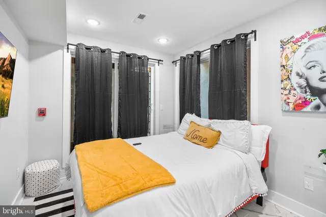 a bedroom with a bed and wall painting