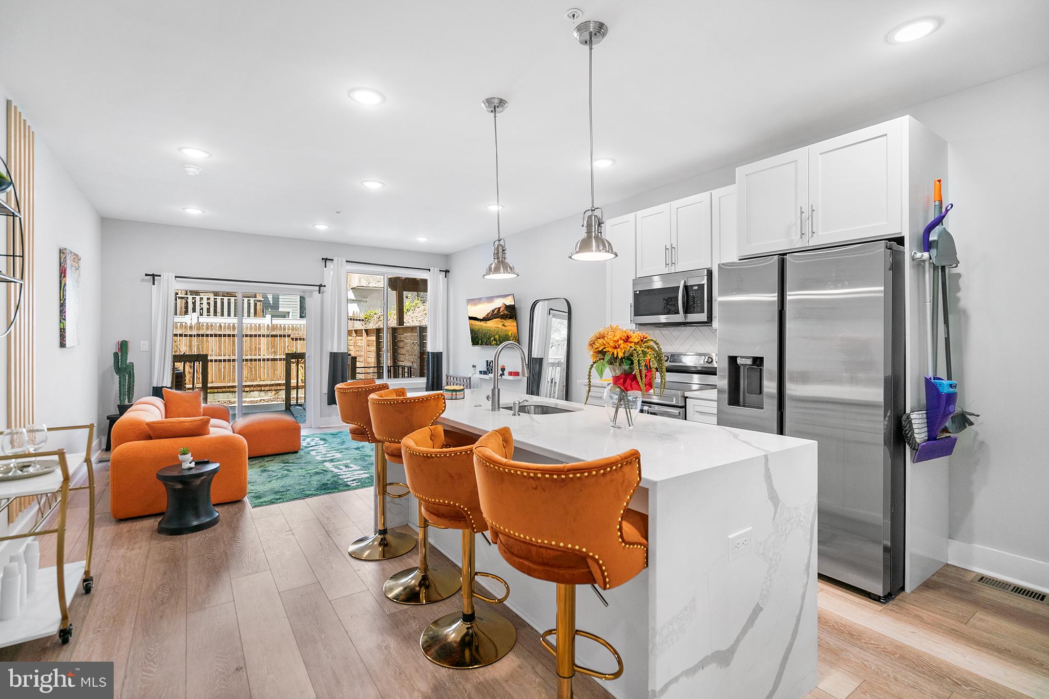 1924 North 6th Street, Unit 2 Philadelphia, PA 19122 - Photo 2 of 15 a view of a dining room with furniture a chandelier and wooden floor
