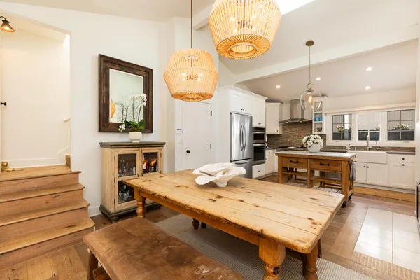 a kitchen with a table chairs and a stove