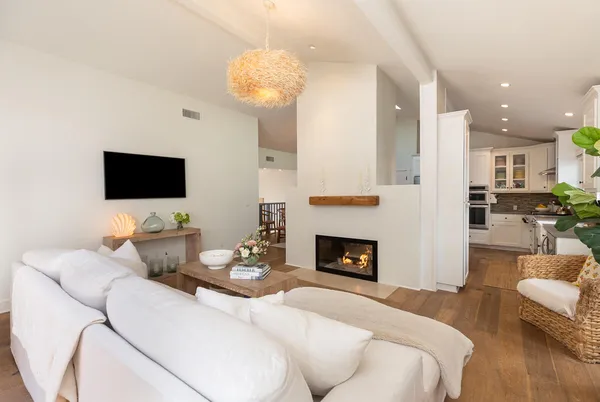 a living room with furniture a fireplace and a flat screen tv
