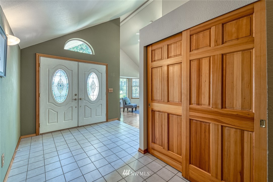 7025 Vandermark Road East Bonney Lake, WA 98391 - Photo 2 of 25 an empty room with wooden floor and mirror