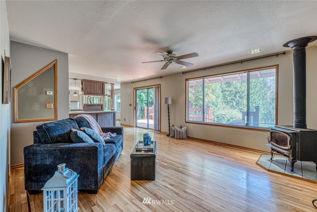 7025 Vandermark Road East Bonney Lake, WA 98391 - Photo 11 of 25 a living room with furniture and a large window