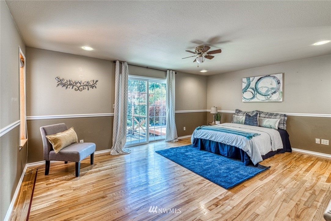 7025 Vandermark Road East Bonney Lake, WA 98391 - Photo 12 of 25 a spacious bedroom with a bed and window