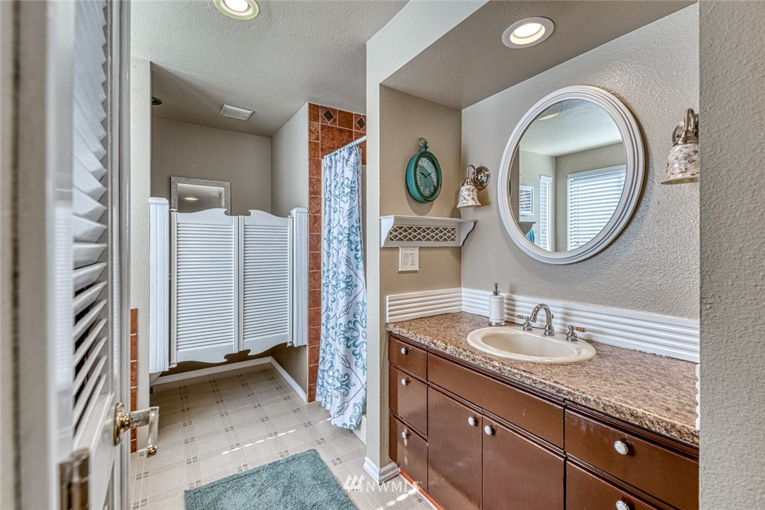 7025 Vandermark Road East Bonney Lake, WA 98391 - Photo 13 of 25 a bathroom with a sink and a mirror