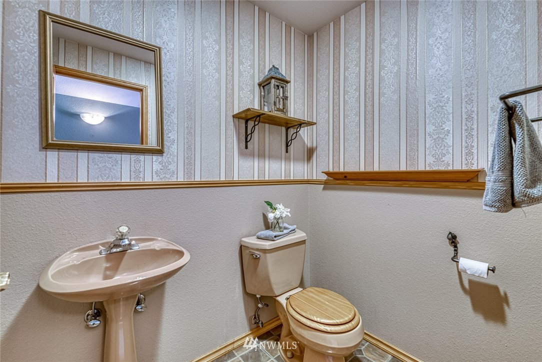 7025 Vandermark Road East Bonney Lake, WA 98391 - Photo 15 of 25 a bathroom with a sink a mirror and a toilet