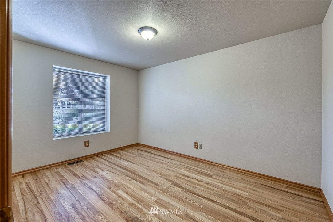 7025 Vandermark Road East Bonney Lake, WA 98391 - Photo 19 of 25 a view of room with window and hardwood floor