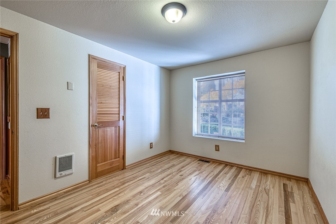 7025 Vandermark Road East Bonney Lake, WA 98391 - Photo 20 of 25 wooden floor in an empty room with a window