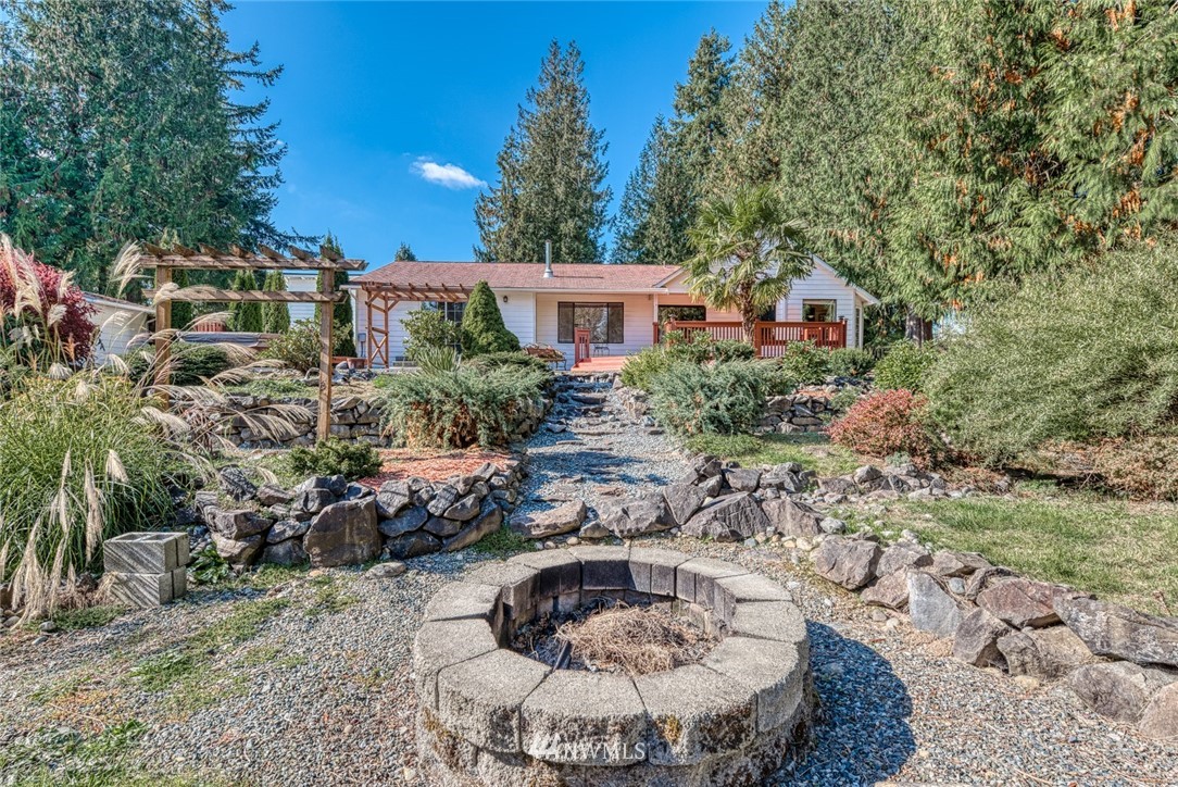 7025 Vandermark Road East Bonney Lake, WA 98391 - Photo 22 of 25 a backyard of a house with a yard and outdoor seating