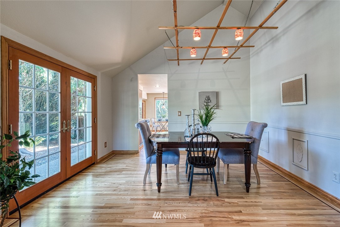 7025 Vandermark Road East Bonney Lake, WA 98391 - Photo 4 of 25 a view of a dining room with furniture window and wooden floor