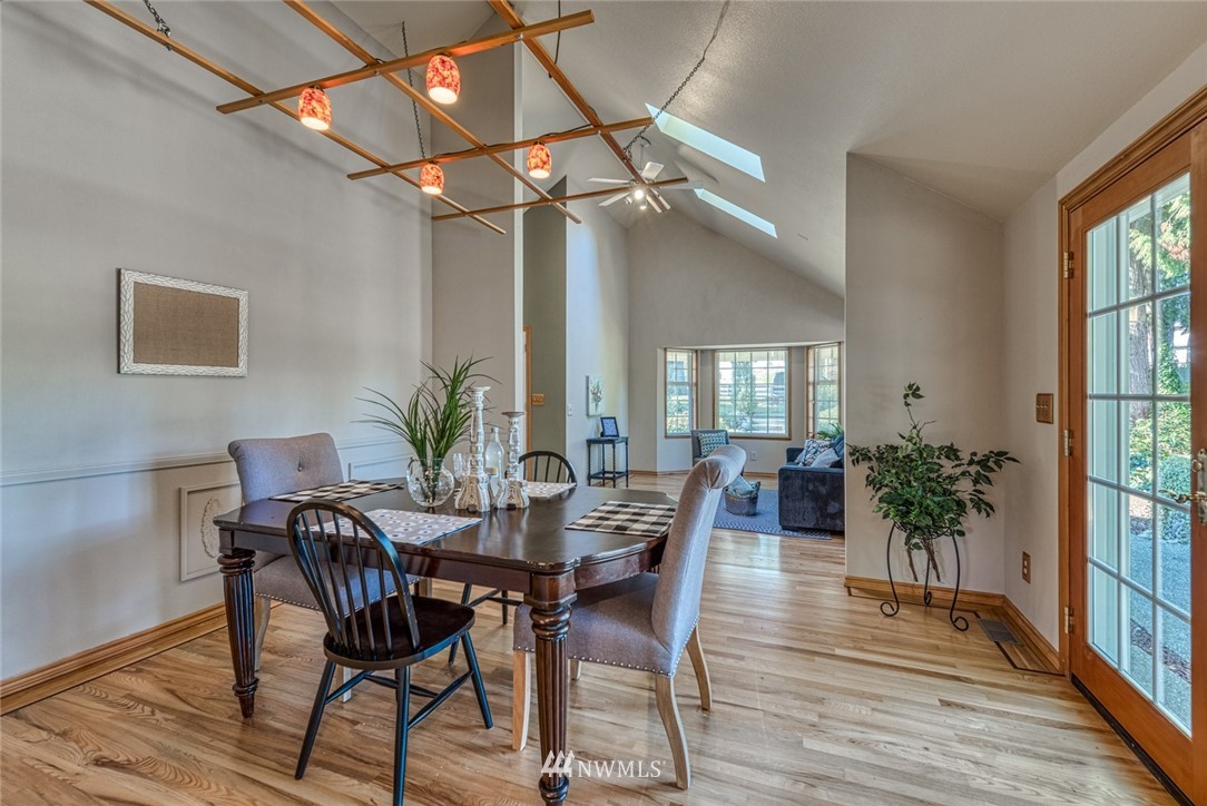 7025 Vandermark Road East Bonney Lake, WA 98391 - Photo 5 of 25 a view of a dining room with furniture window and wooden floor
