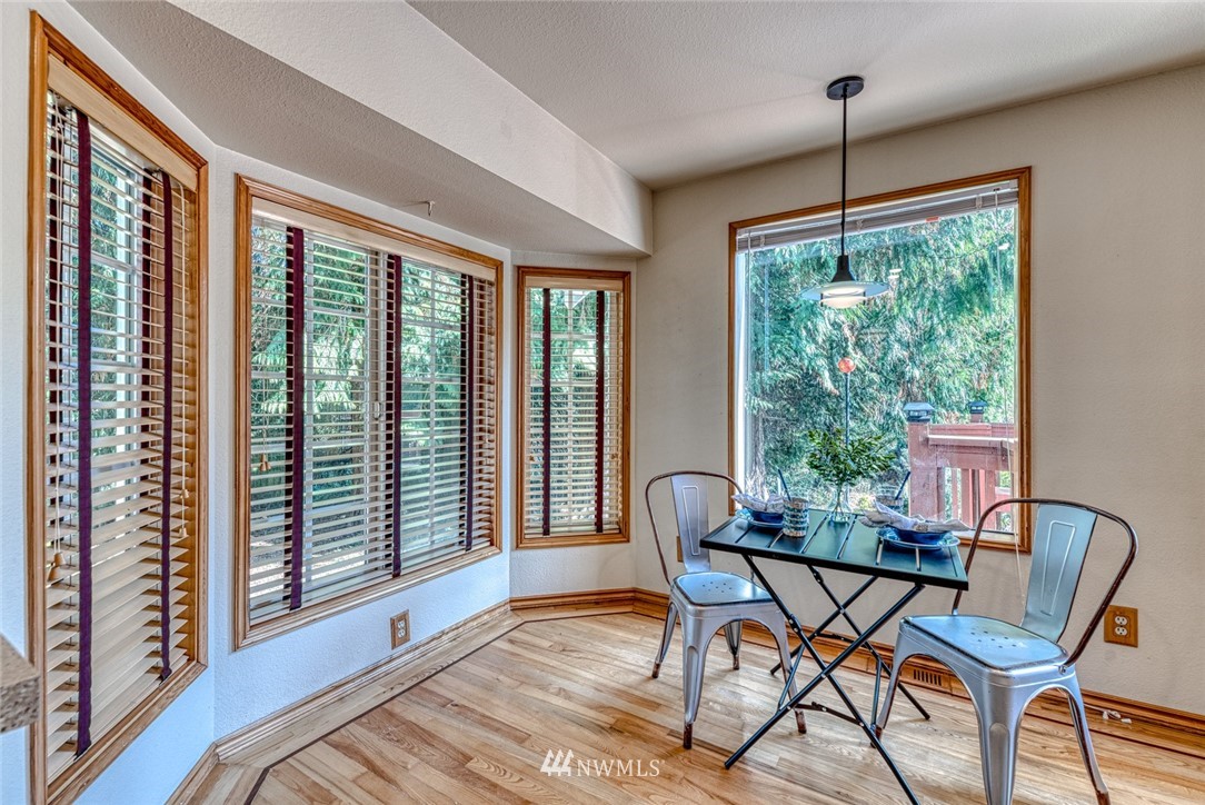 7025 Vandermark Road East Bonney Lake, WA 98391 - Photo 9 of 25 a view of a dining room with furniture window and wooden floor