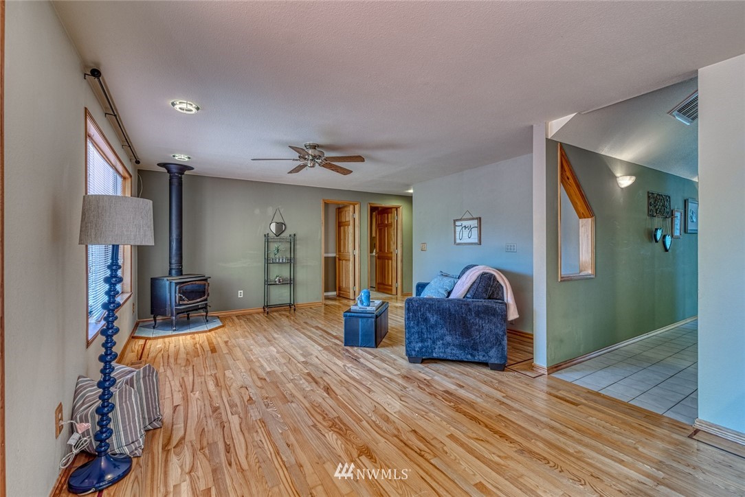 7025 Vandermark Road East Bonney Lake, WA 98391 - Photo 10 of 25 a living room with furniture and a wooden floor