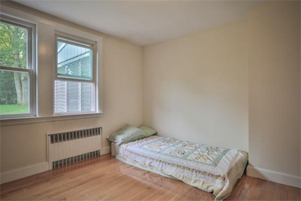 141 Ridge Street Winchester, MA 01890 - Photo 12 of 20 a bedroom with a bed and a window