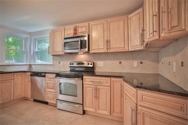 141 Ridge Street Winchester, MA 01890 - Photo 2 of 20 a kitchen with stainless steel appliances granite countertop a sink and a stove
