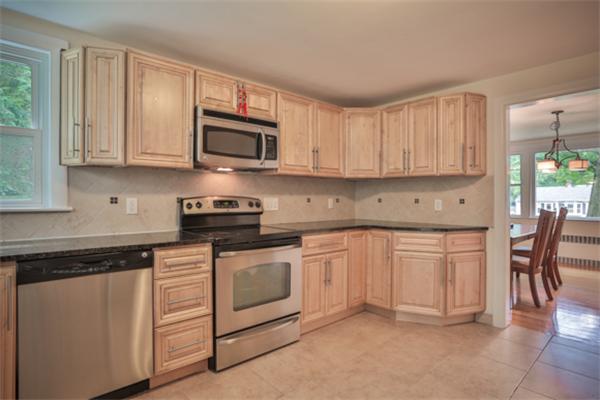 141 Ridge Street Winchester, MA 01890 - Photo 3 of 20 a kitchen with granite countertop white cabinets sink and stainless steel appliances