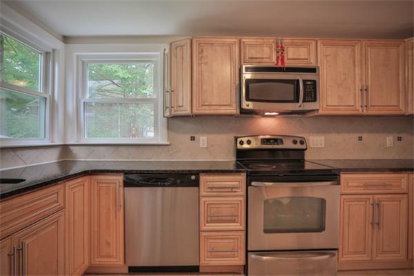 141 Ridge Street Winchester, MA 01890 - Photo 4 of 20 a kitchen with stainless steel appliances granite countertop a stove a microwave and a sink