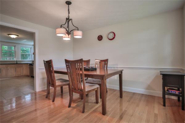 141 Ridge Street Winchester, MA 01890 - Photo 5 of 20 a dining room with wooden floor a chandelier a wooden table and chairs
