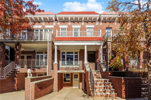 a front view of a building with glass windows and refrigerator