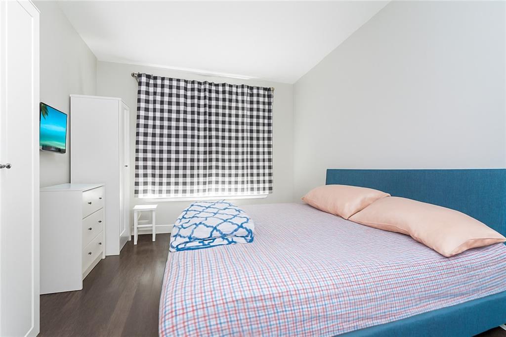 227 94th Street Brooklyn, NY 11209 - Photo 13 of 34 a bedroom with a bed and wooden floor