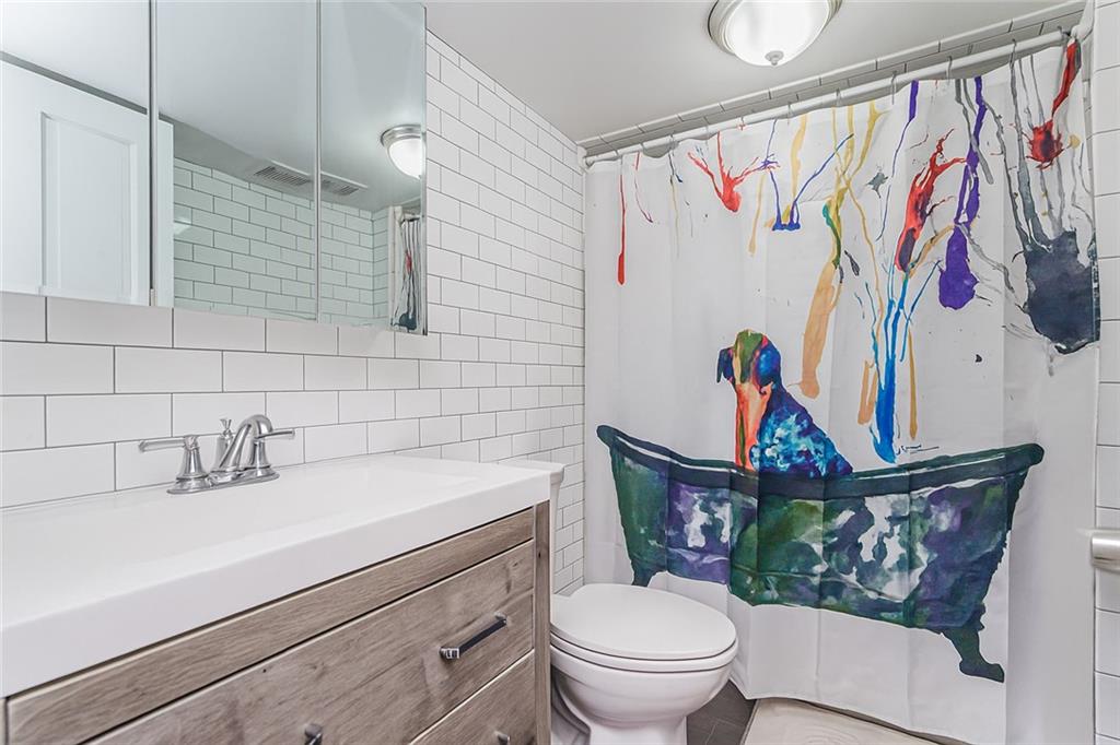 227 94th Street Brooklyn, NY 11209 - Photo 14 of 34 a bathroom with a toilet sink and mirror