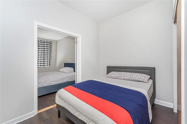 a bedroom with a bed and a lamp