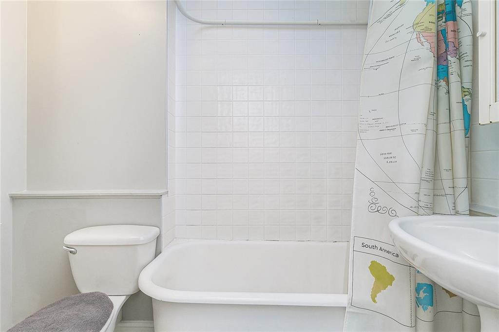 227 94th Street Brooklyn, NY 11209 - Photo 18 of 34 a bathroom with a sink and bathtub