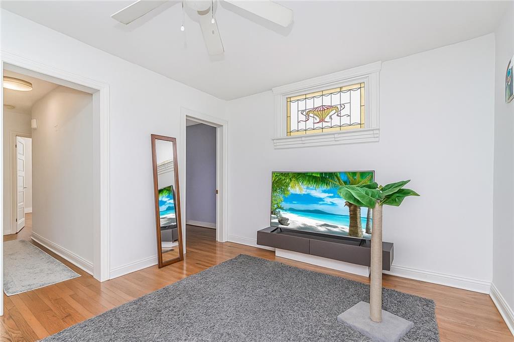 227 94th Street Brooklyn, NY 11209 - Photo 19 of 34 a living room with furniture and a flat screen tv
