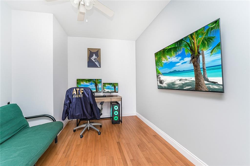 227 94th Street Brooklyn, NY 11209 - Photo 21 of 34 a view of a workspace with furniture and screen tv