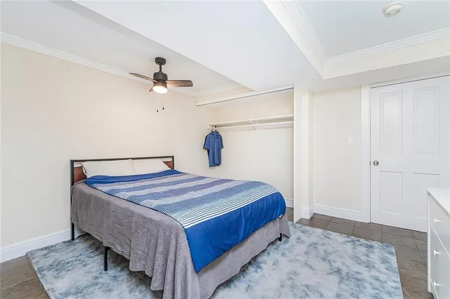 a bedroom with a bed and a ceiling fan