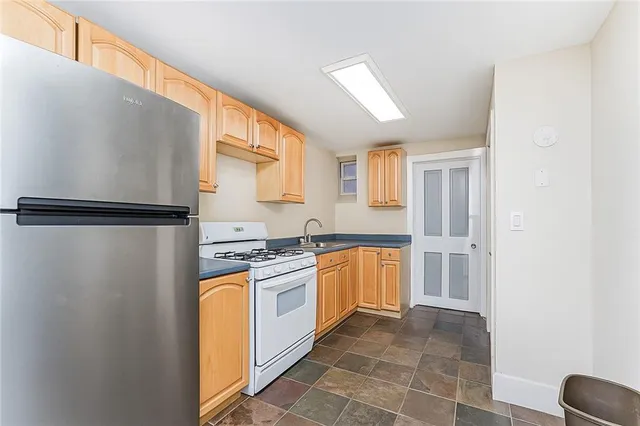 a kitchen with stainless steel appliances granite countertop a refrigerator and a stove top oven