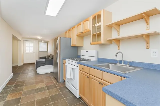 a kitchen with a sink cabinets and appliances