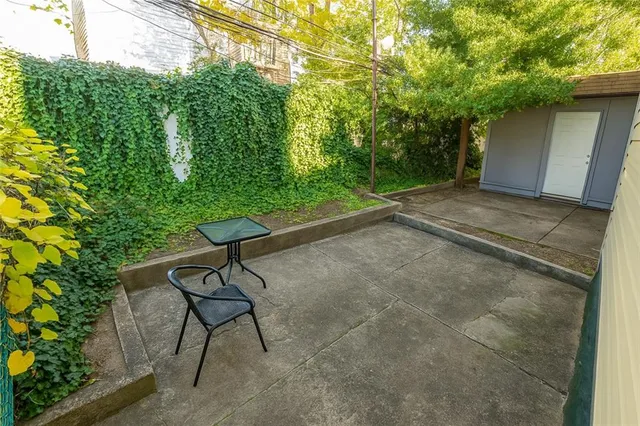 a view of a backyard with furniture and a garage