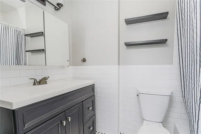 a bathroom with a sink toilet and vanity