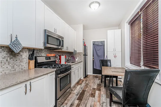 a kitchen with a stove a sink and a microwave