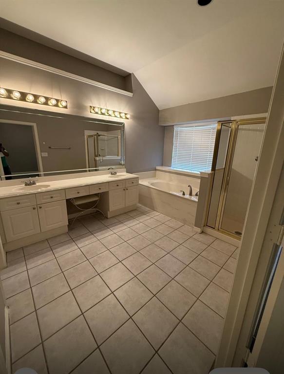 8001 Kings Ridge Road Frisco, TX 75035 - Photo 5 of 13 Bathroom with tile patterned flooring, vanity, lofted ceiling, and independent shower and bath