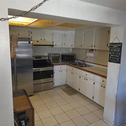 a kitchen with stainless steel appliances a stove sink and cabinets
