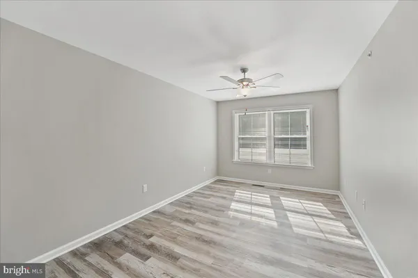 a view of wooden floor and windows in a room