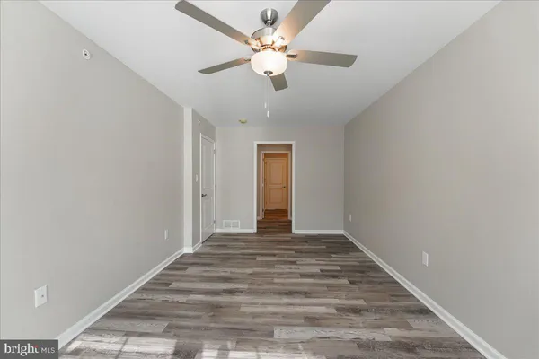 a view of an empty room with a ceiling fan
