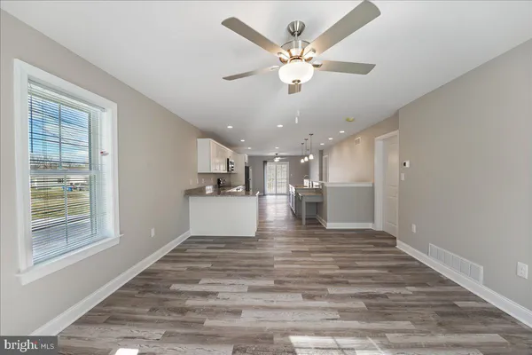 a view of kitchen and hall with wooden floor