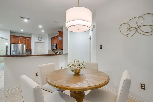 a dining room with table and chairs